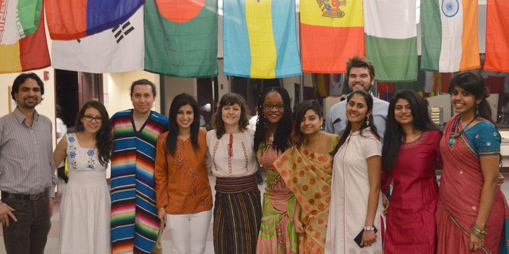 More international students pose in front of international flags