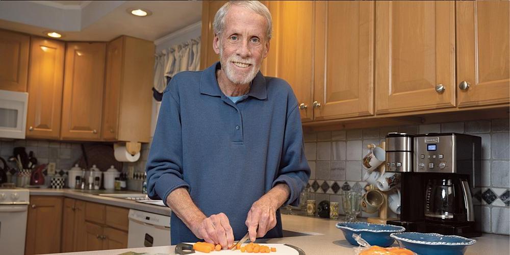 Donald Gregory says of his battle with prostate cancer: “I survived it. It wasn’t easy. It was uncomfortable, but it gets better with time.” He is shown in the kitchen of his Camillus home. (photo by Susan Kahn)